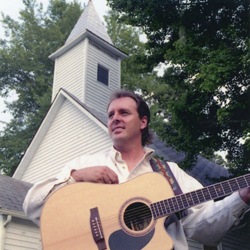Steve-Gosney-in-front-of-church-with-guitar