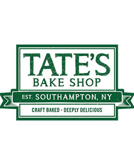 Green and white logo for Tate’s Bake Shop, established in Southampton, NY, featuring “Craft Baked,” “Deeply Delicious,” and a nod to their famous cookies.